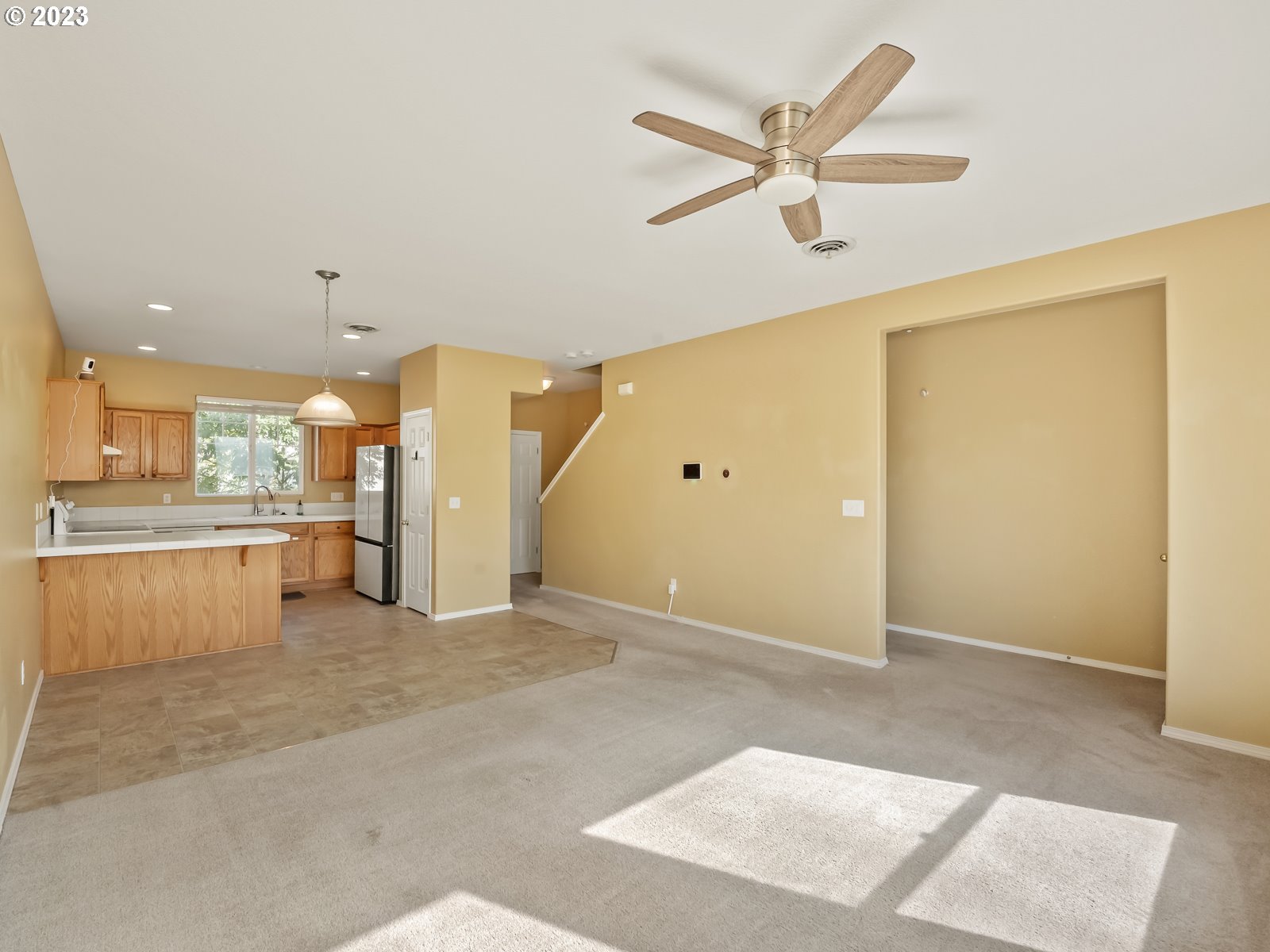 12226 Southeast Long Street Portland, OR 97236 - Photo 6 of 29 a view of an empty room with kitchen and a window