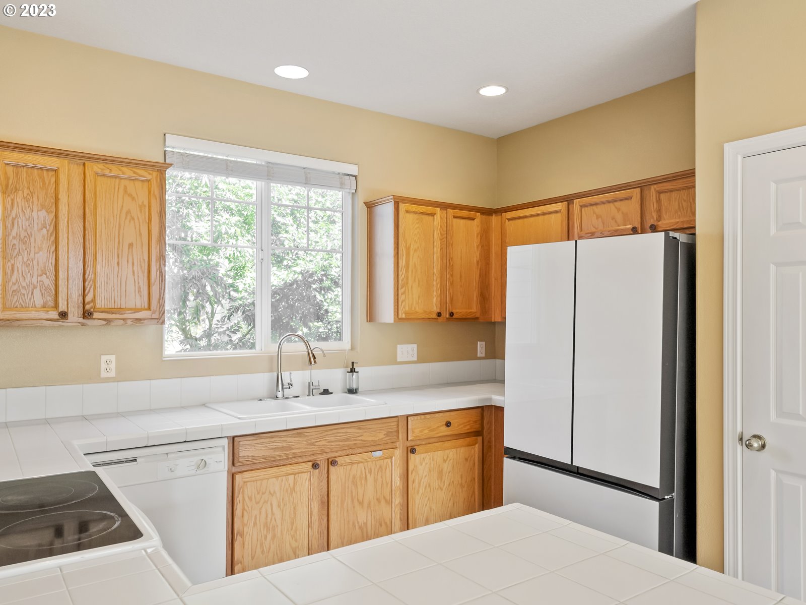 12226 Southeast Long Street Portland, OR 97236 - Photo 10 of 29 a kitchen with stainless steel appliances a refrigerator sink and cabinets