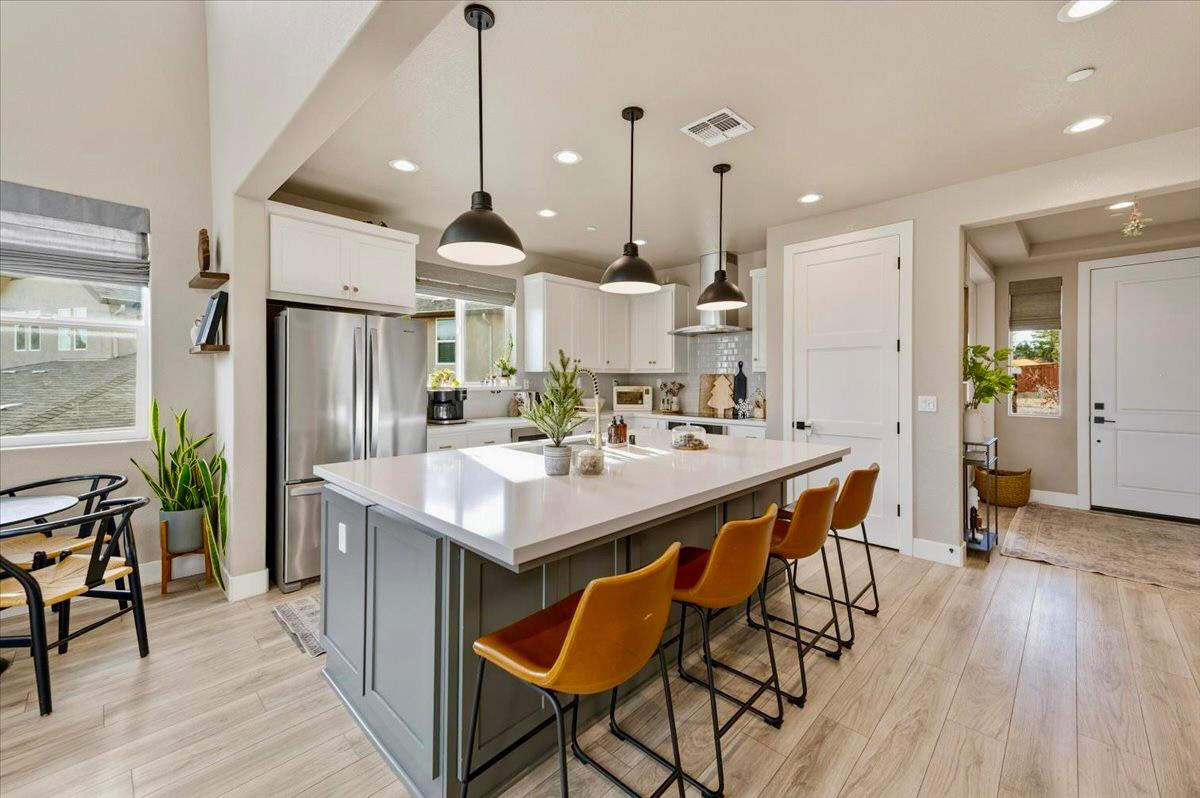 508 Chase Court Colfax, CA 95713 - Photo 9 of 34 a kitchen with stainless steel appliances a dining table chairs stove and refrigerator