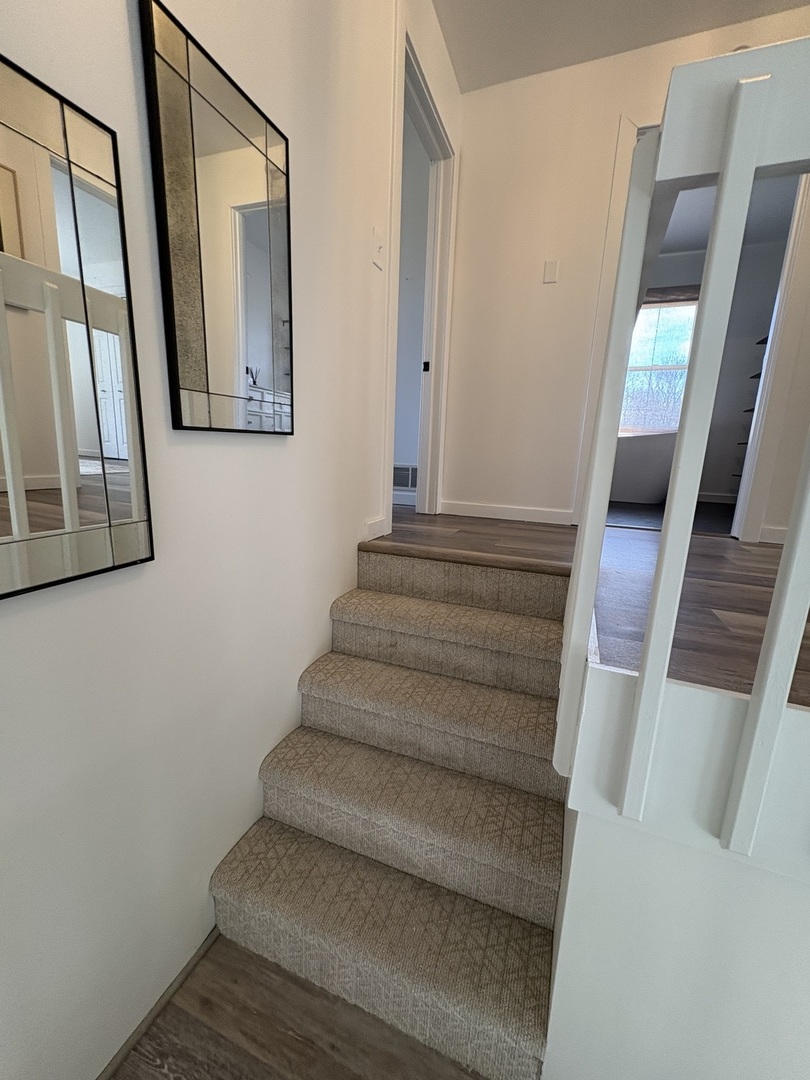 1124 North Clark Lane Elizabeth, IL 61028 - Photo 18 of 50 a view of staircase with wooden floor and a mirror