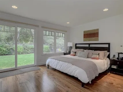 a bedroom with a large bed and a large window
