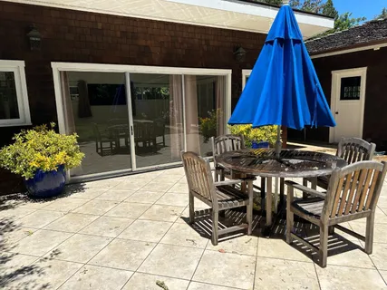 a table and chairs in front of the house