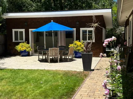 a view of a house with sitting area and garden