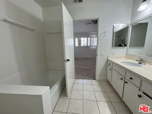 a bathroom with a double vanity sink toilet and shower
