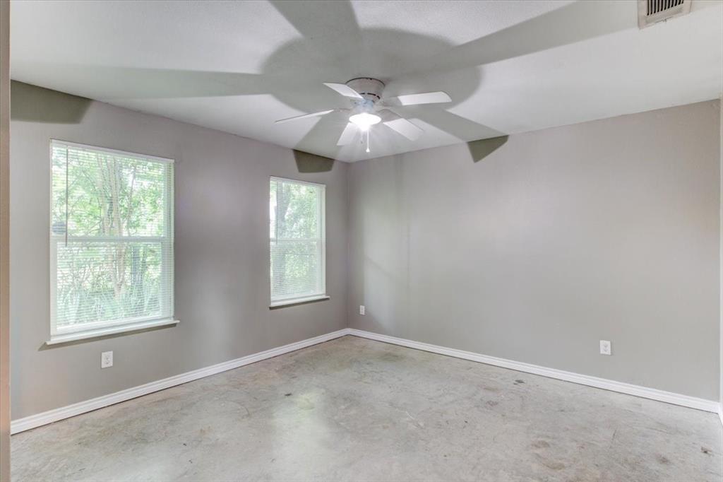 3558 Winston Road Fort Worth, TX 76109 - Photo 16 of 24 an empty room with windows and fan