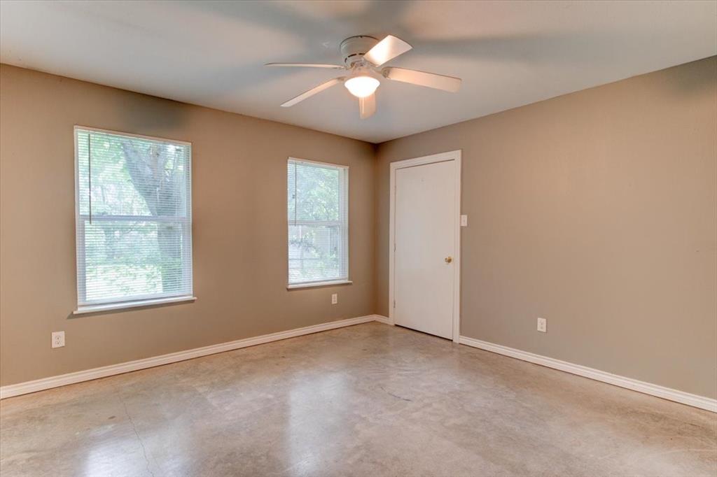 3558 Winston Road Fort Worth, TX 76109 - Photo 19 of 24 an empty room with windows and ceiling fan