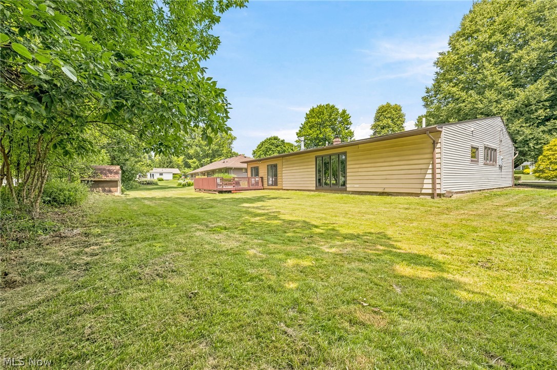 8160 Joyce Road Broadview Heights, OH 44147 - Photo 33 of 45 Expansive grassy yard area with mature trees and a rear deck