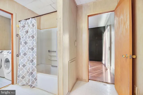 a kitchen with stainless steel appliances a refrigerator and wooden floor