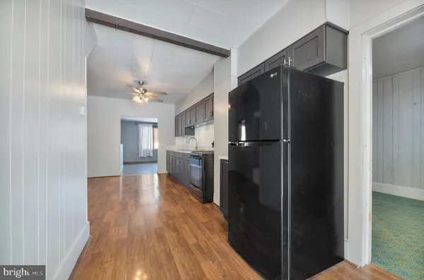 a kitchen with a refrigerator and a sink