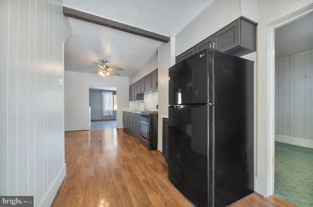 a kitchen with a refrigerator and a sink