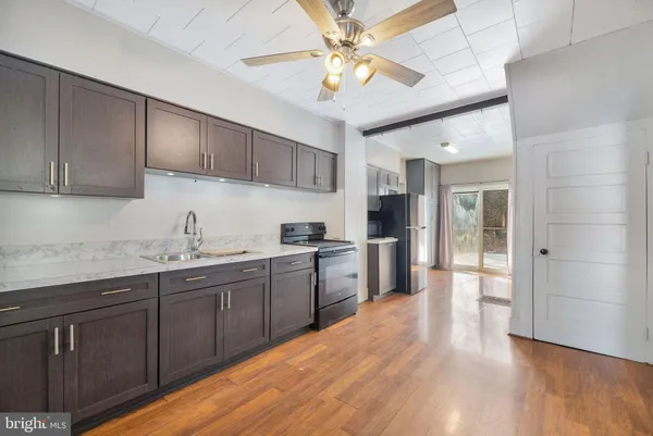 a kitchen with a sink and a refrigerator