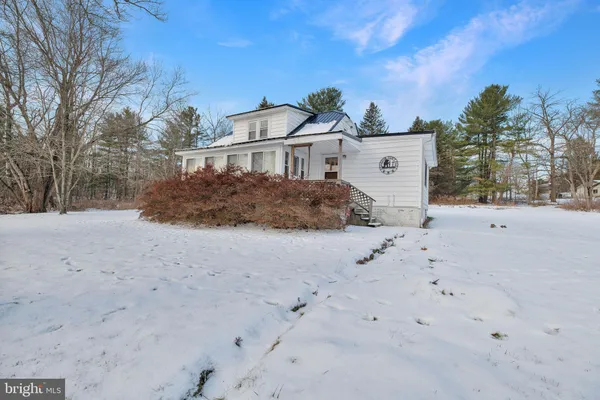 a view of a house with a snow in the yard