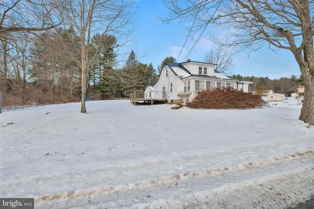 a view of a house with a snow in the yard