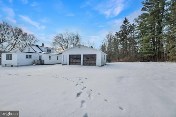 a view of a house with snow on the road