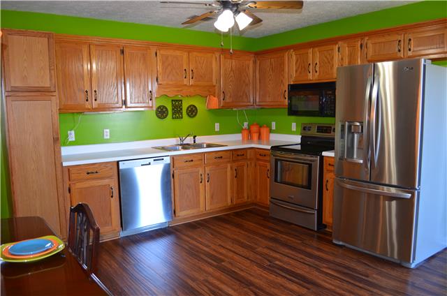 3335 Beckwith Road Mount Juliet, TN 37122 - Photo 6 of 17 Custom oak cabinets, built in microwave, stainless appliances remain. Built in Pantry! Utility room located off from kitchen.