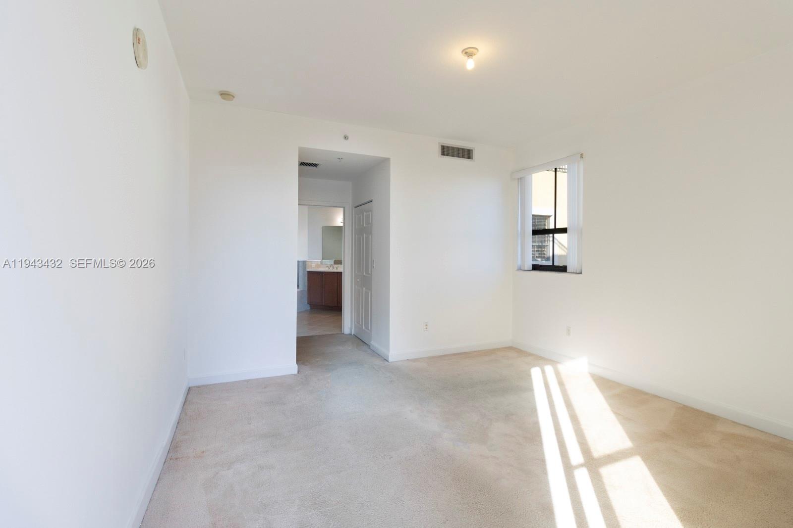 8395 Southwest 73rd Avenue, Unit 528 Miami, FL 33143 - Photo 14 of 27 an empty room with windows and closet