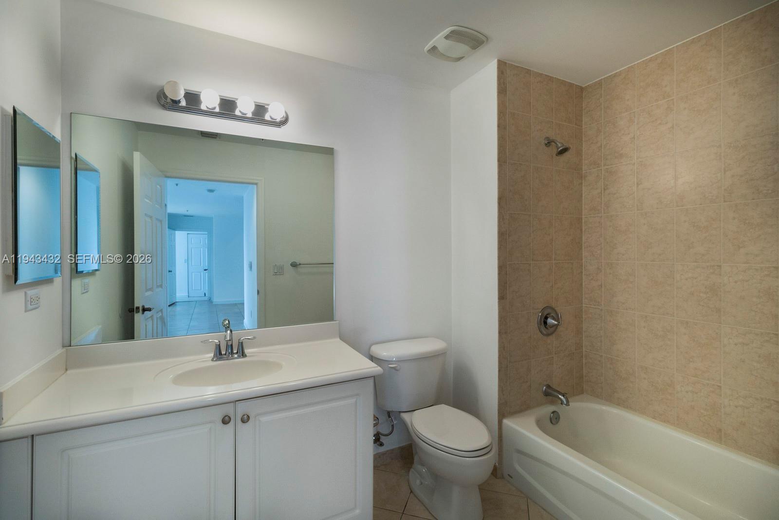 8395 Southwest 73rd Avenue, Unit 528 Miami, FL 33143 - Photo 17 of 27 a bathroom with a sink a toilet and shower