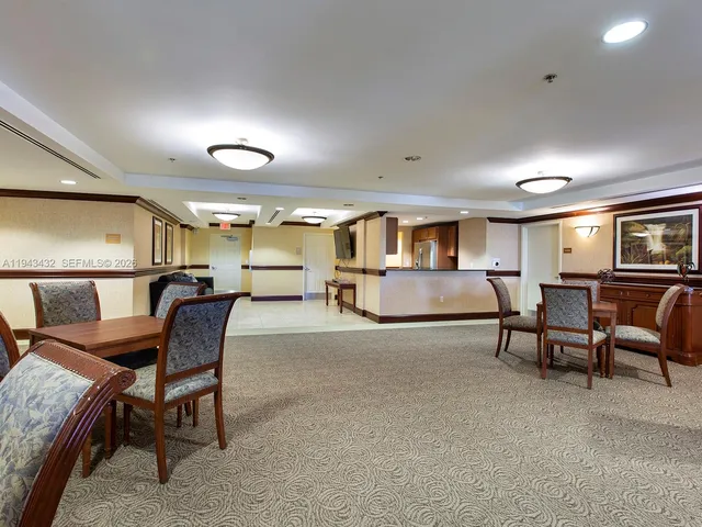 a living room with furniture and a lamp