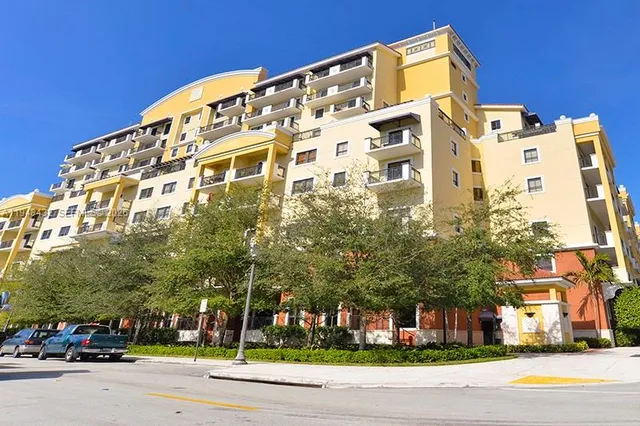 a view of a tall building next to a road
