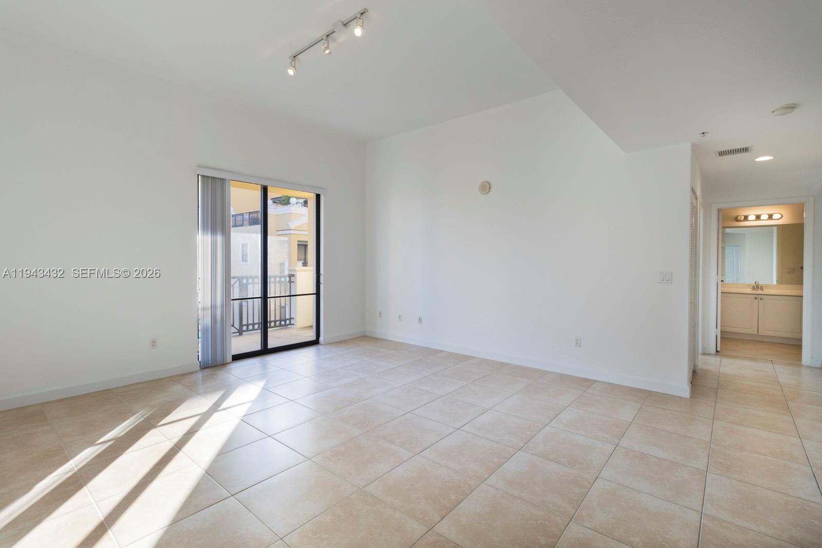 8395 Southwest 73rd Avenue, Unit 528 Miami, FL 33143 - Photo 3 of 27 an empty room with entrance and windows