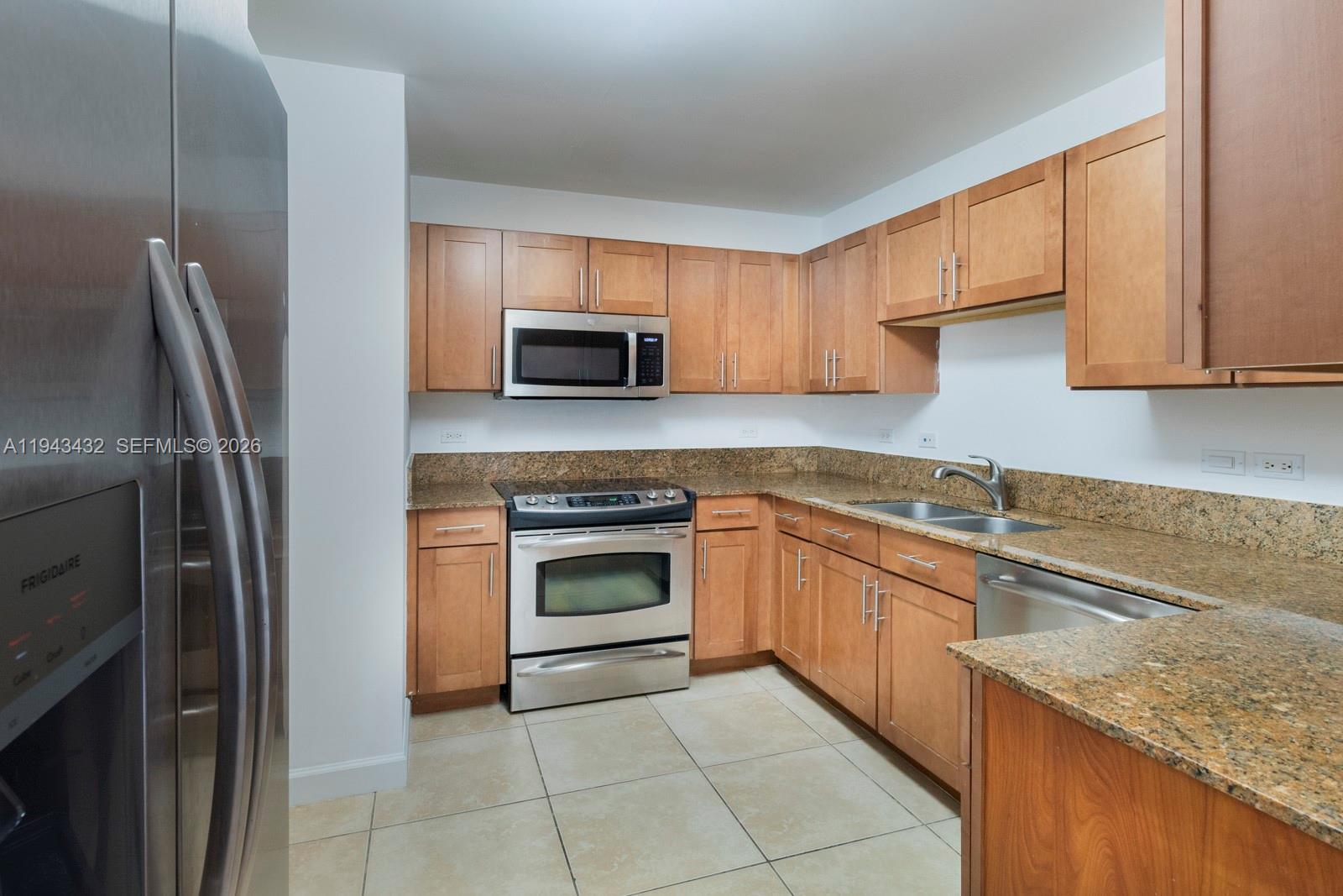 8395 Southwest 73rd Avenue, Unit 528 Miami, FL 33143 - Photo 7 of 27 a kitchen with cabinets appliances and a sink
