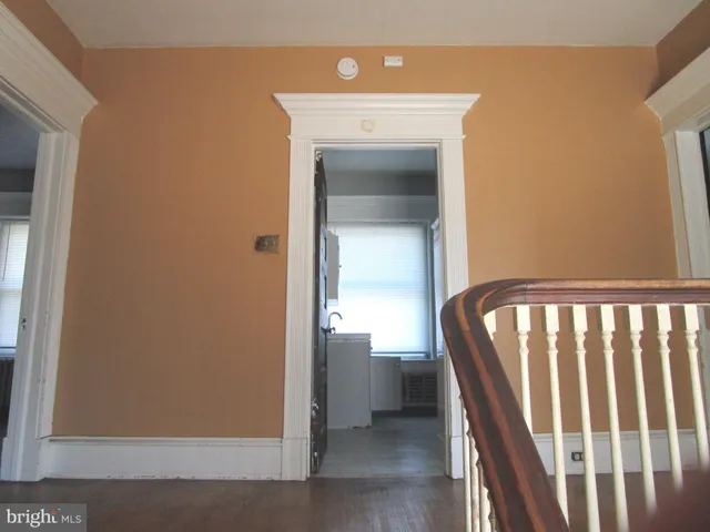 a view of a hallway with entryway door