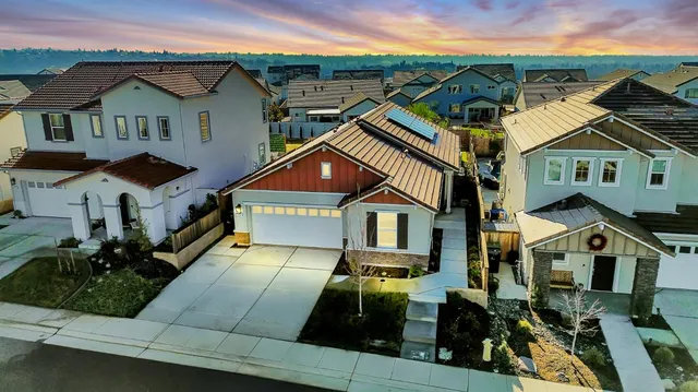 an aerial view of a house with a yard