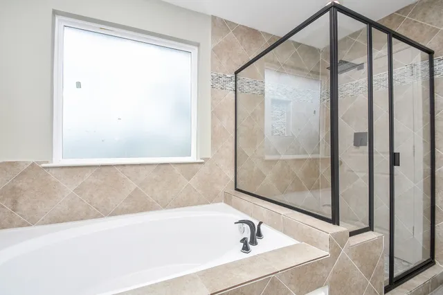a bathroom with a bathtub and a shower