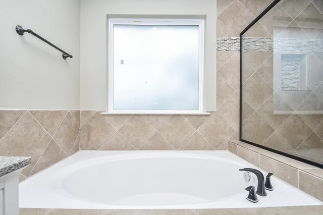 a bathroom with a bathtub and a shower