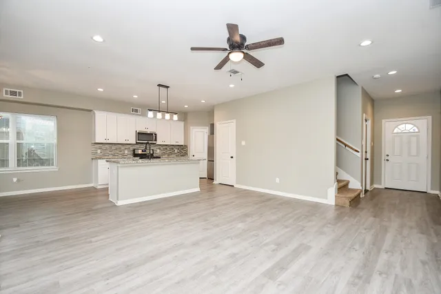 a view of a kitchen with a sink and a window