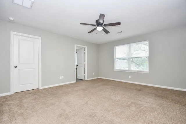 a view of an empty room with a window