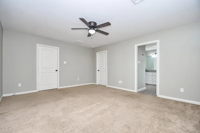 a view of an empty room with a ceiling fan