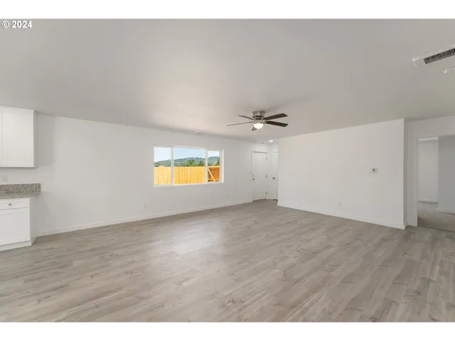 a view of an empty room and a window