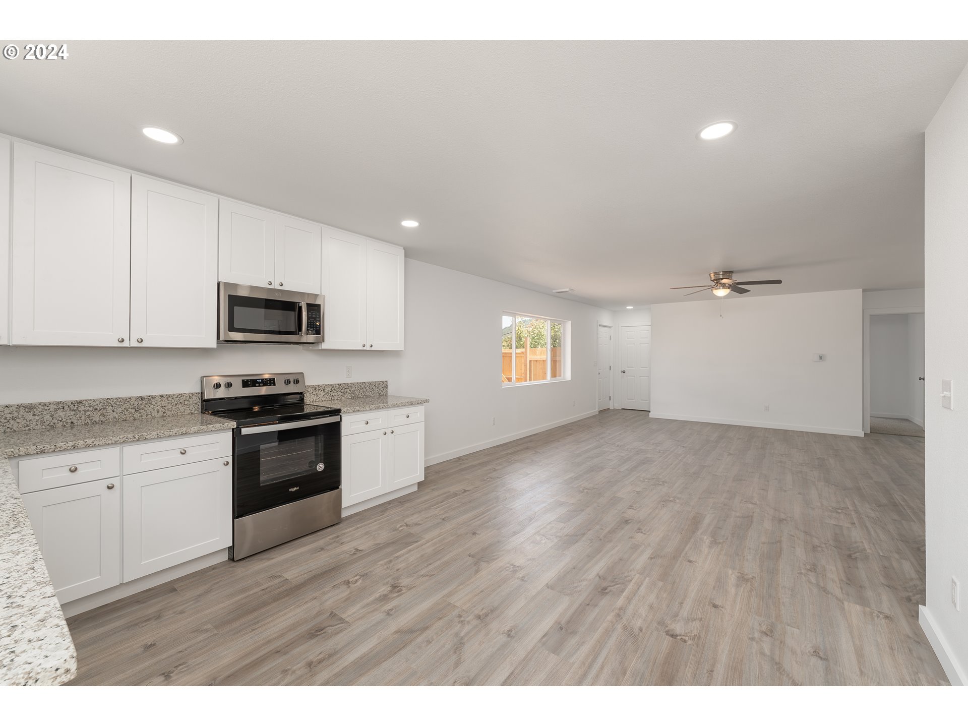 1237 Southeast Washington Avenue Roseburg, OR 97470 - Photo 16 of 28 a kitchen with granite countertop a stove top oven and sink