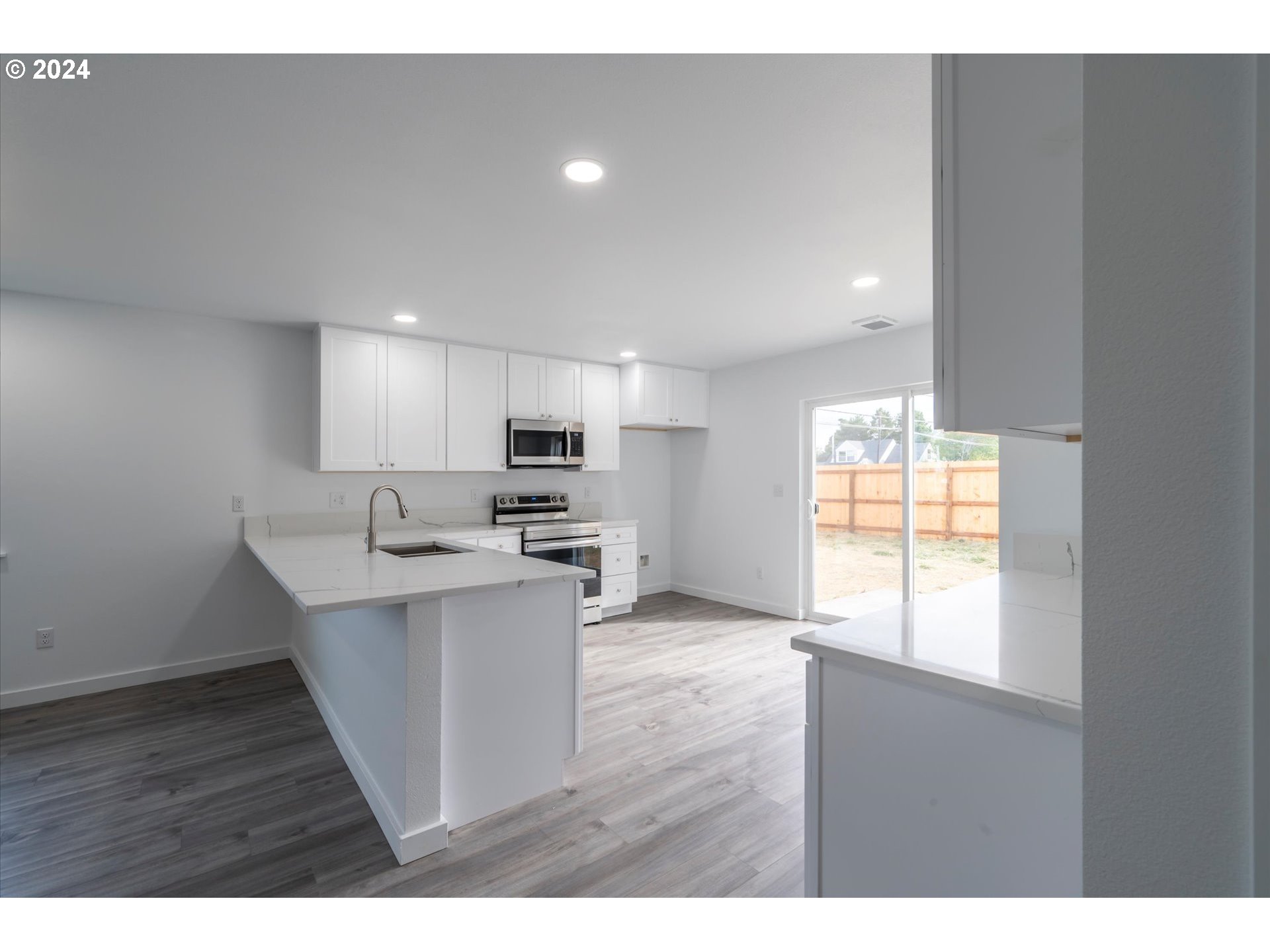 1237 Southeast Washington Avenue Roseburg, OR 97470 - Photo 6 of 28 a open kitchen with stainless steel appliances granite countertop a sink and window