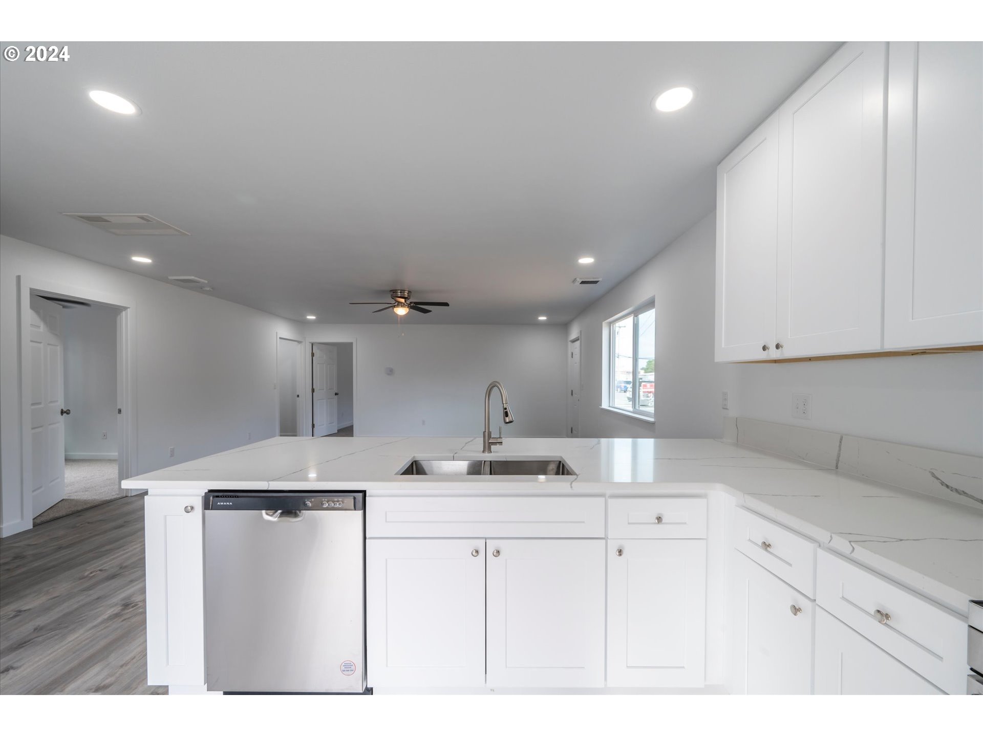 1237 Southeast Washington Avenue Roseburg, OR 97470 - Photo 9 of 28 a kitchen with kitchen island a sink and cabinets
