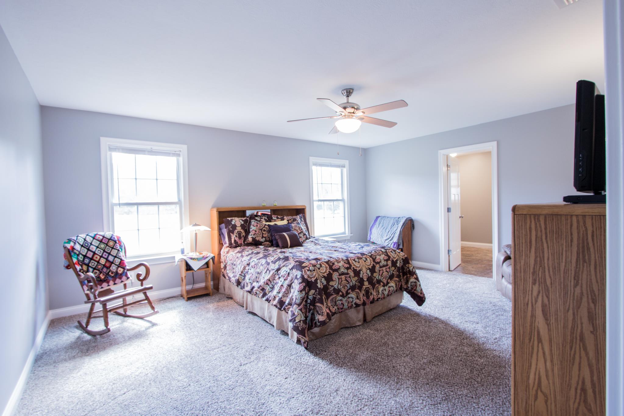 2082 Wayside Road Manchester, TN 37355 - Photo 17 of 30 a bedroom with a bed a chair and potted plant on the dresser