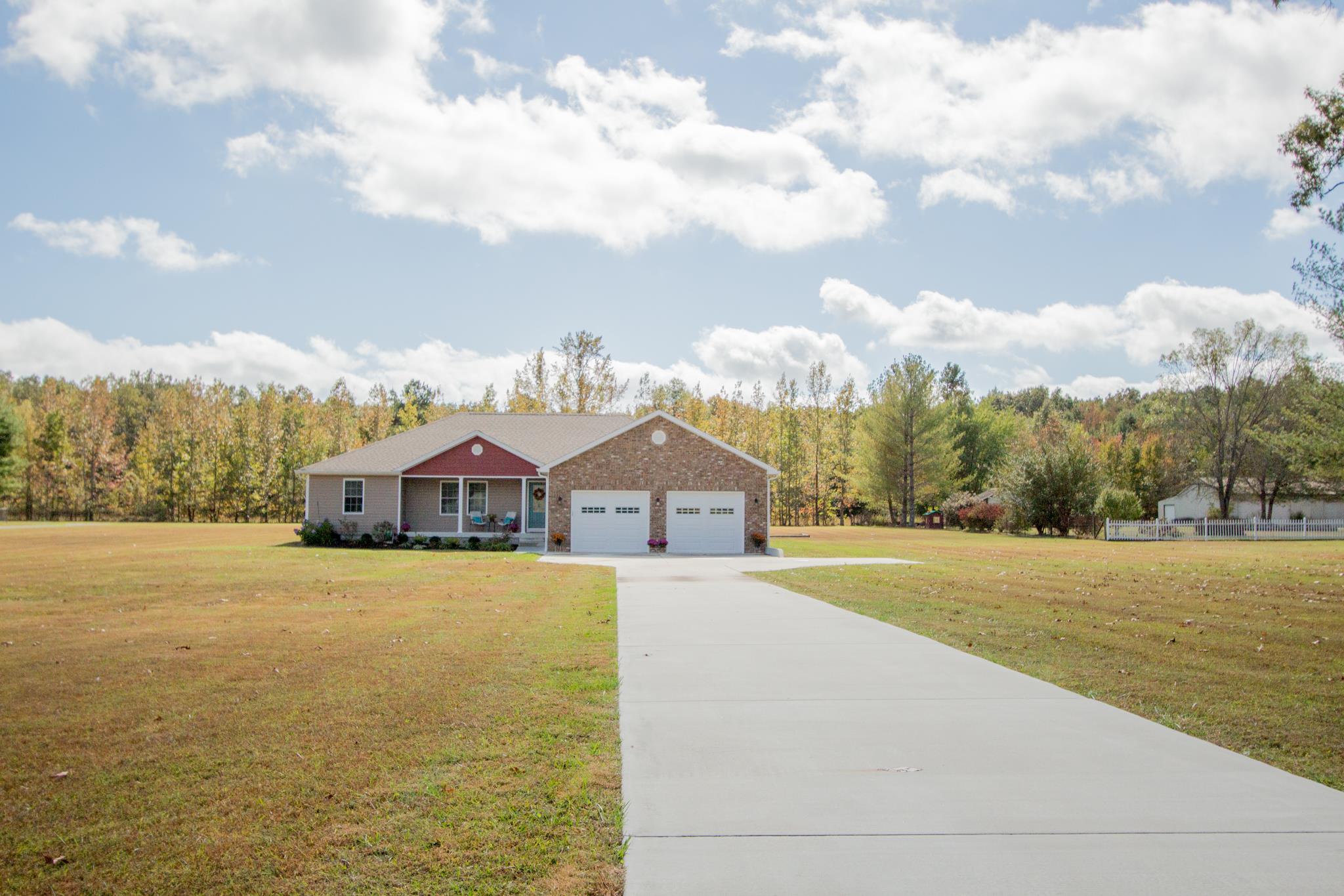 2082 Wayside Road Manchester, TN 37355 - Photo 6 of 30 a front view of a house with a yard and trees