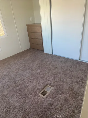 a view of an empty room with windows