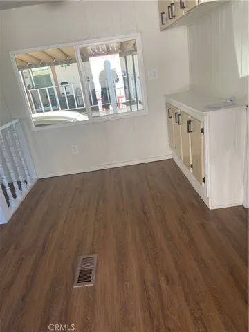 a view of walk in closet with wooden floor