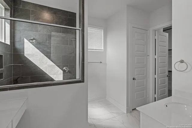 a bathroom with a bathtub and a shower