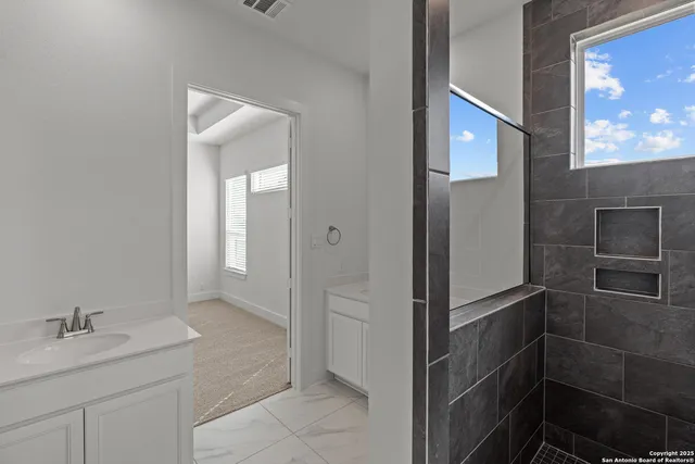 a bathroom with a sink and mirror