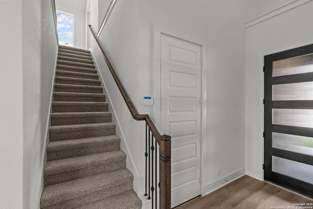a view of entryway and hall with wooden floor