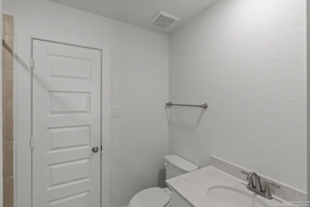 a white toilet sitting next to a bathroom sink