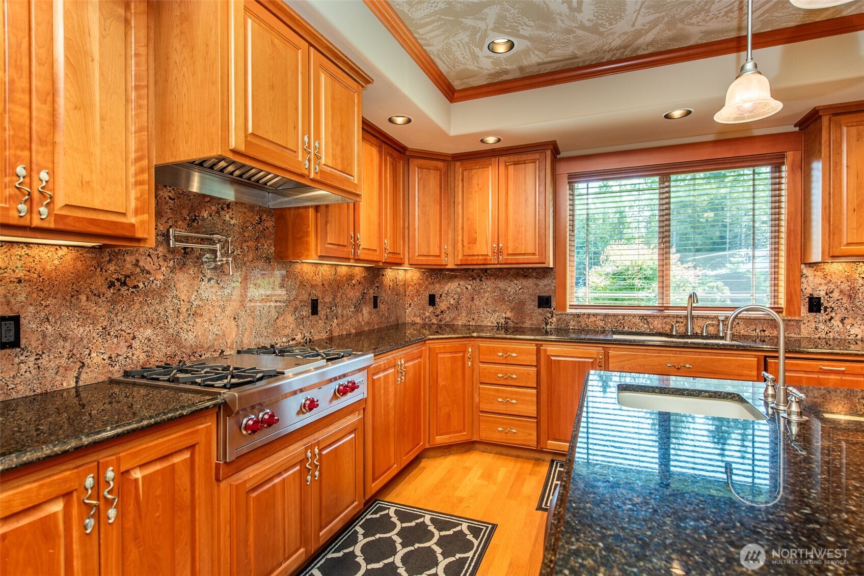 1065 Henry Boyd Road Port Angeles, WA 98362 - Photo 12 of 40 a kitchen with stainless steel appliances granite countertop a stove a sink and a microwave