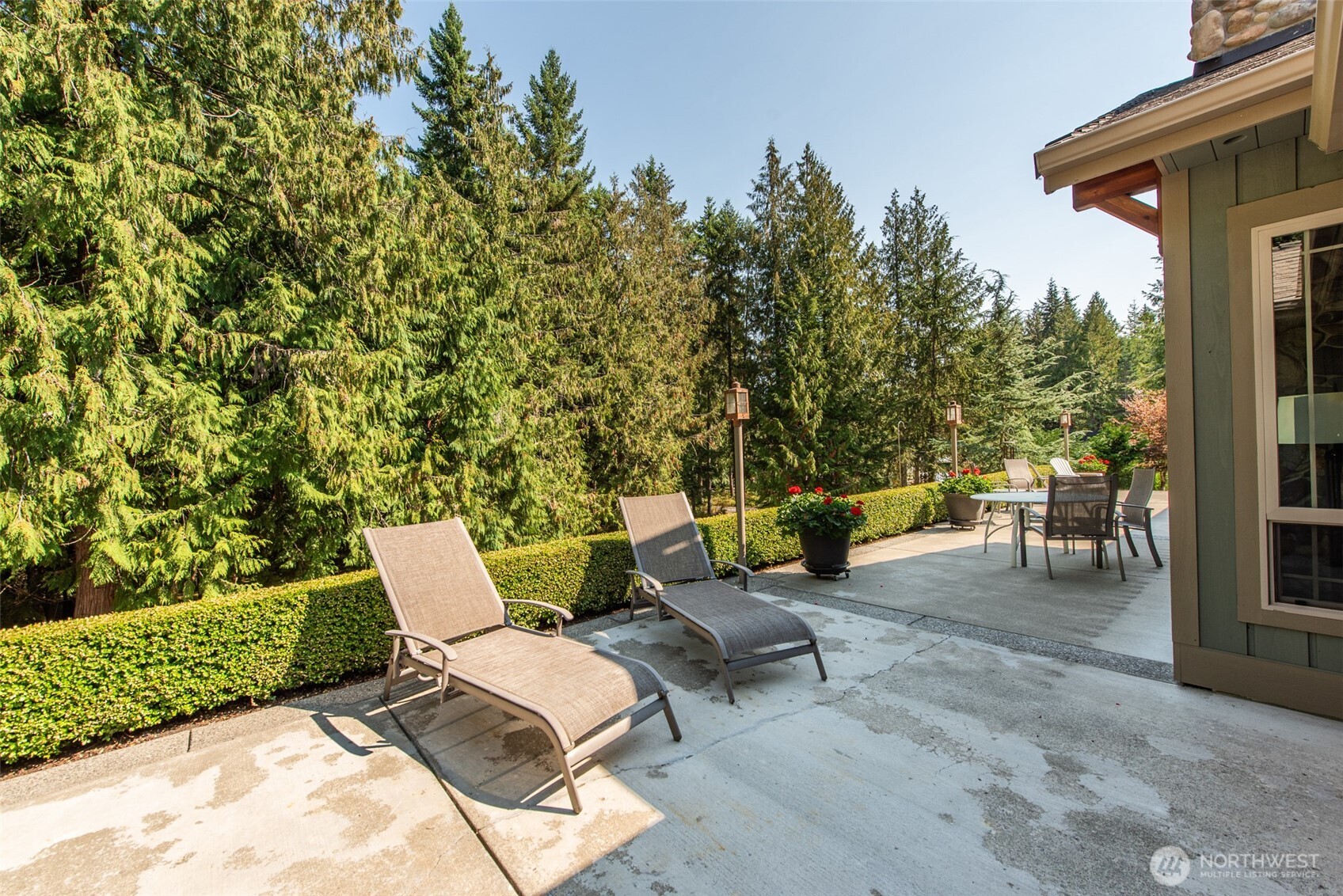 1065 Henry Boyd Road Port Angeles, WA 98362 - Photo 18 of 40 a backyard of a house with table and chairs
