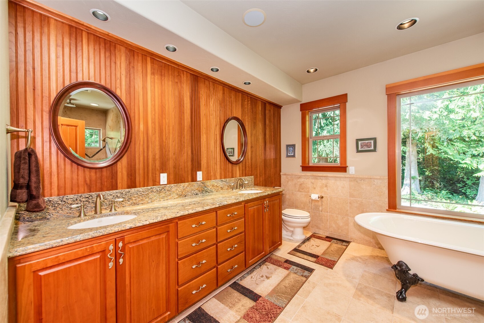 1065 Henry Boyd Road Port Angeles, WA 98362 - Photo 19 of 40 a bathroom with a granite countertop double vanity sink a mirror and a window