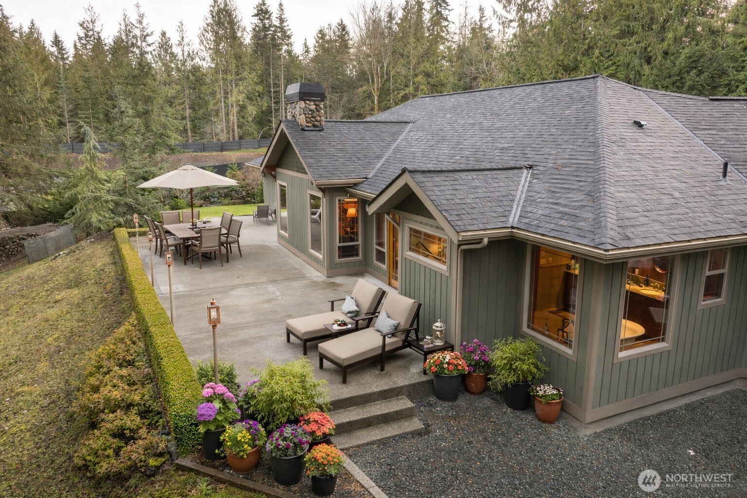 1065 Henry Boyd Road Port Angeles, WA 98362 - Photo 2 of 40 a aerial view of a house with table and chairs potted plants