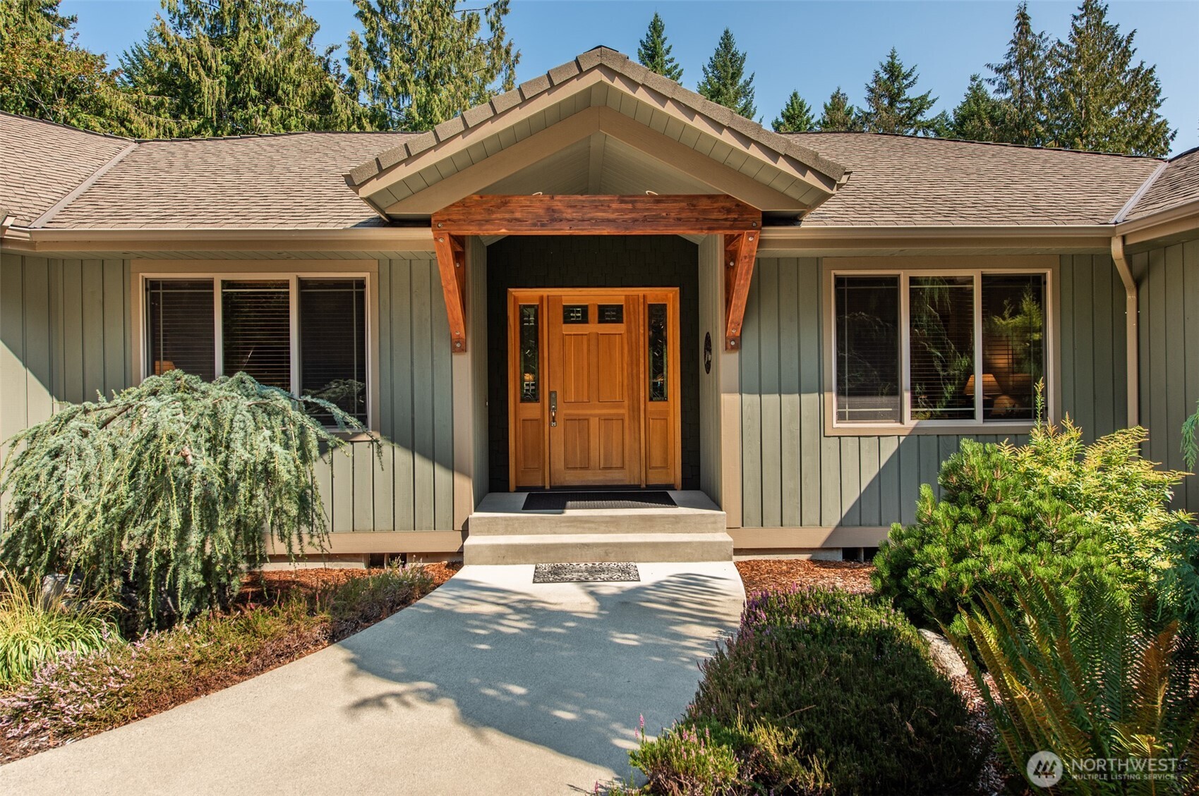 1065 Henry Boyd Road Port Angeles, WA 98362 - Photo 3 of 40 a front view of a house with a garden