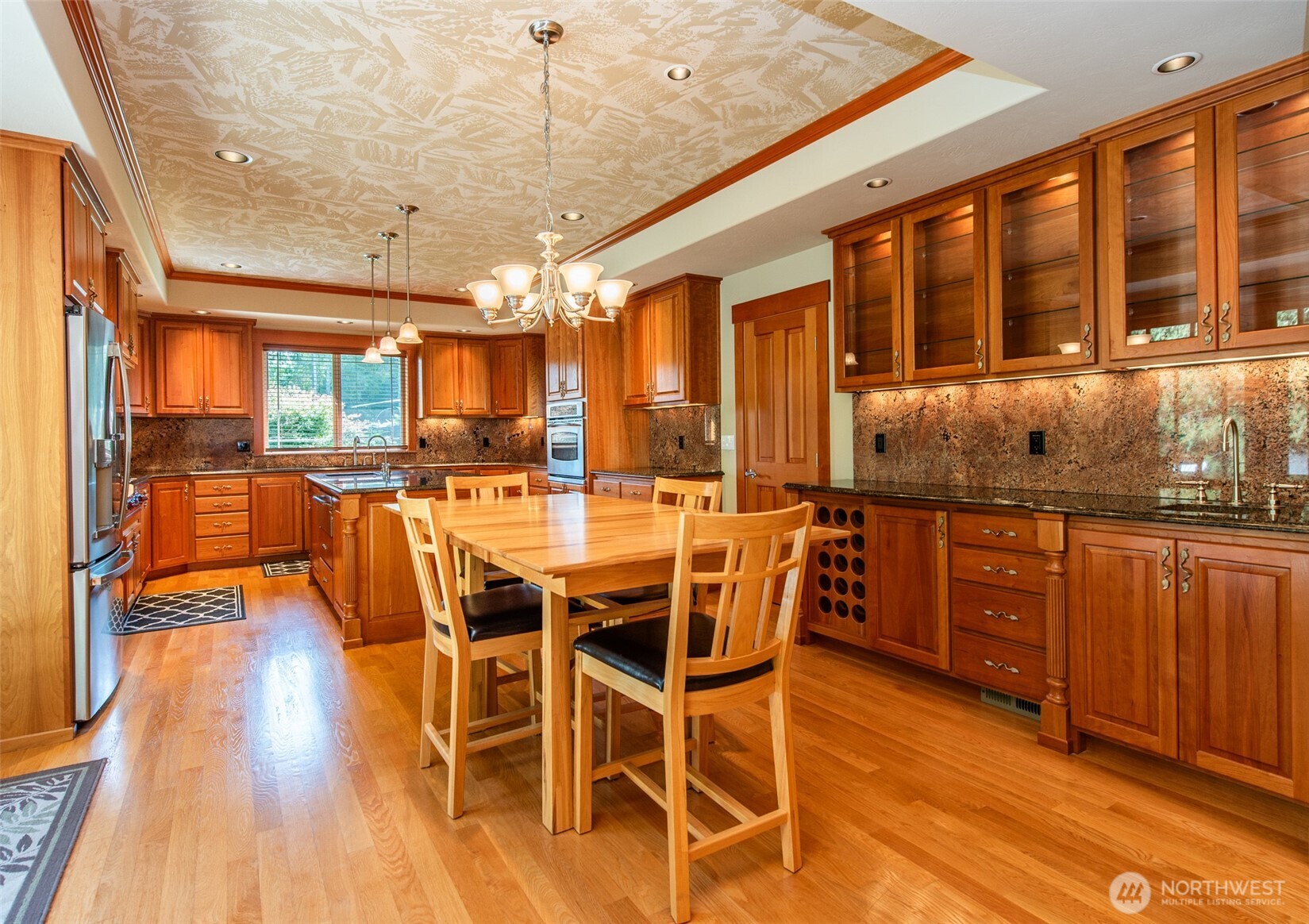 1065 Henry Boyd Road Port Angeles, WA 98362 - Photo 8 of 40 a view of a dining room with furniture wooden floor and chandelier